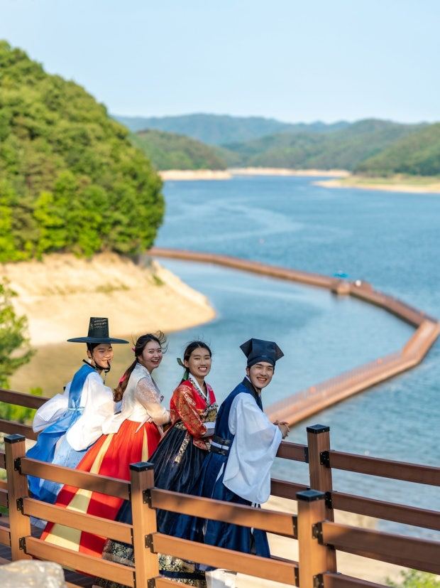 Guests in hanbok above Andong Lake