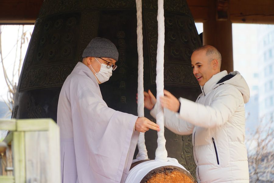 Ringing the temple bell with a monk
